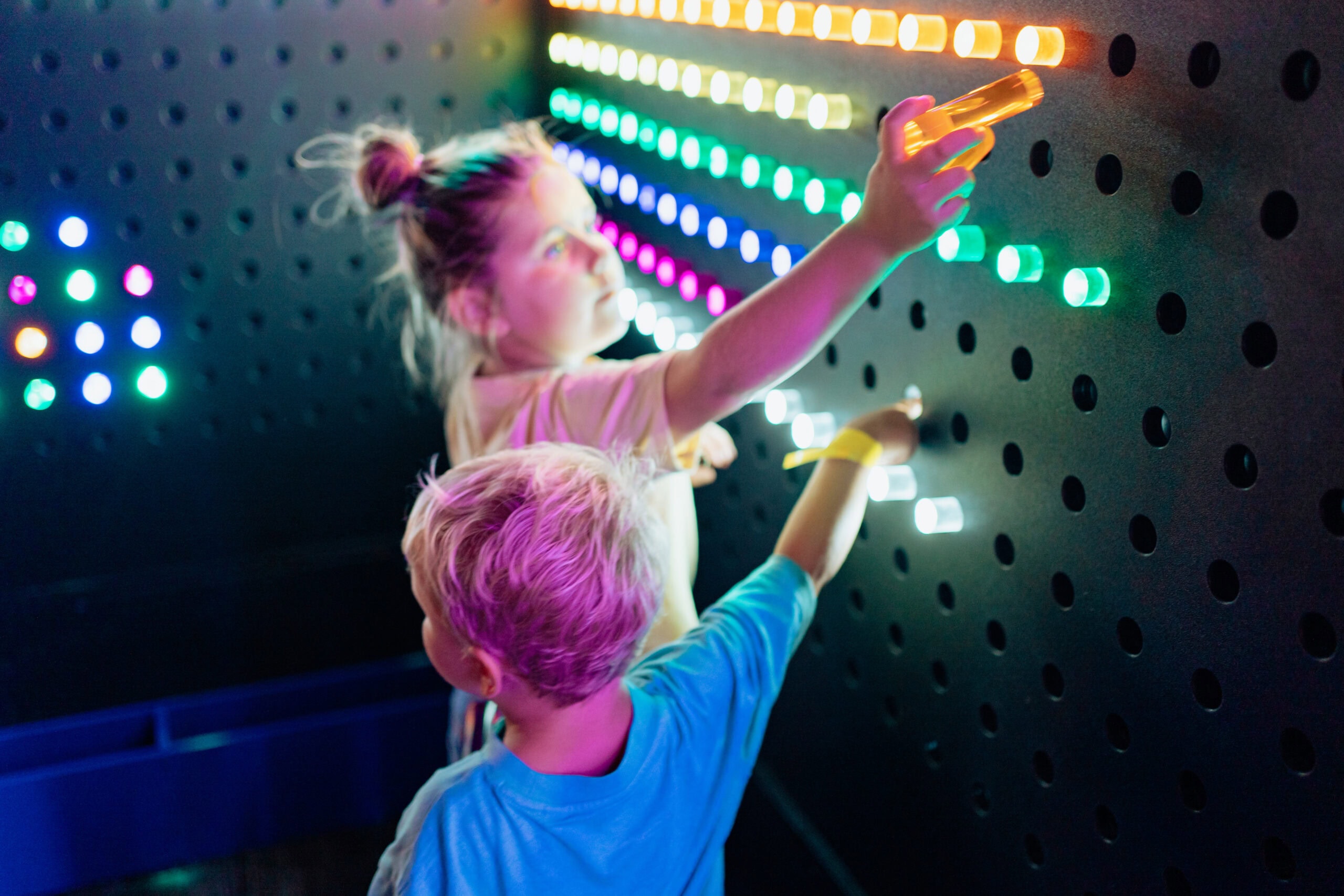 Children playing with interactive light wall in sensory play area