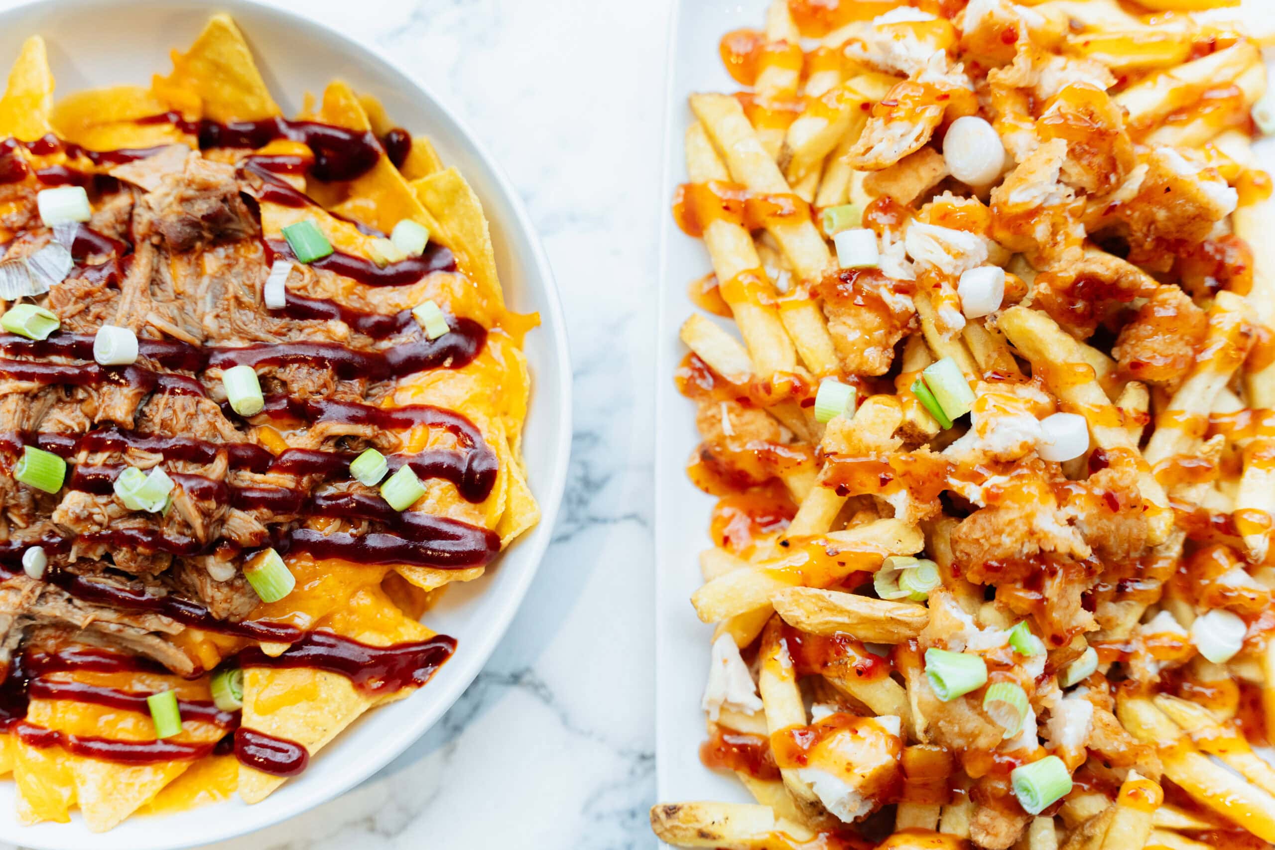 Loaded nachos and chicken loaded pizza fries with sauces in family cafe