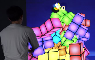 Child playing interactive light up cube game in indoor play center activity zone