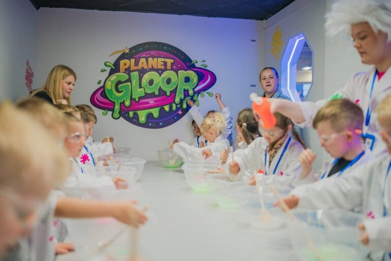 Children in lab coats making slime at Planet Gloop in Hull