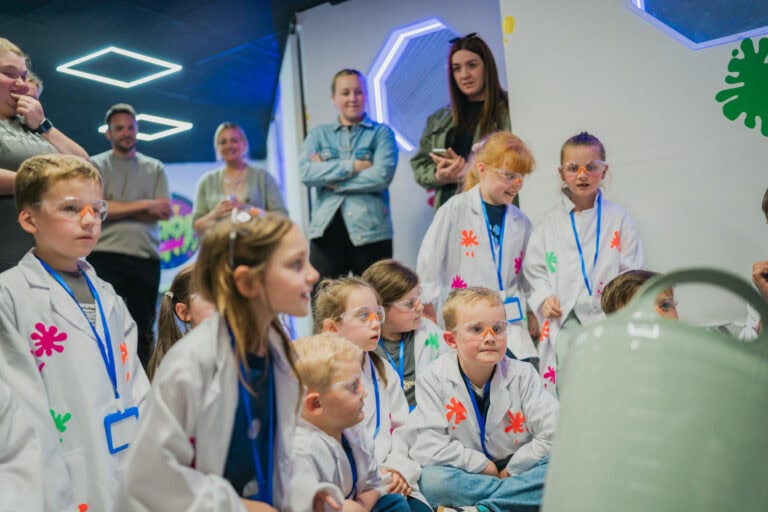 A child adding colour to their slime