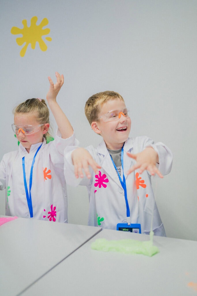 A child holding up their slime creation at Planet Gloop